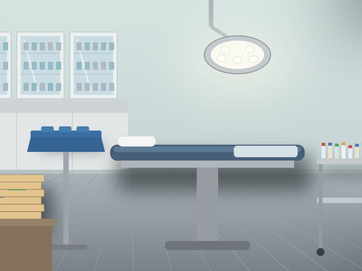 An empty ambulatory surgery center room with a covered instrument tray, unlabeled drug vials, and claim folders for a CMS ASC update